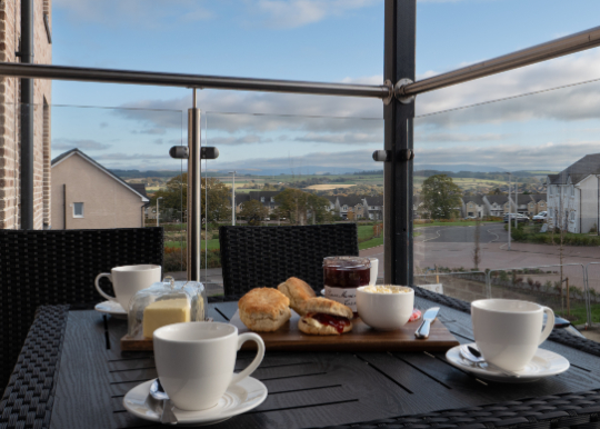 Cream team on a table with a view from a balcony