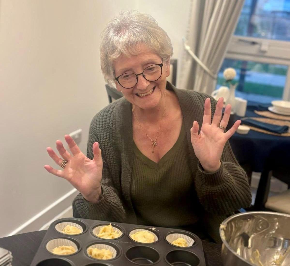 Care home resident baking cupcakes