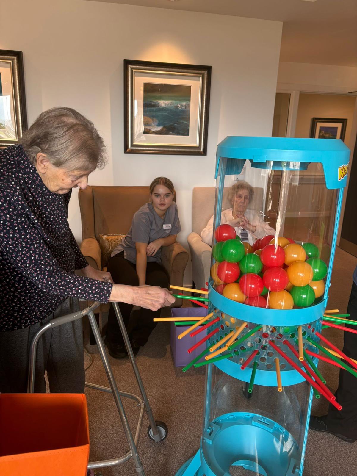 care homes residents playing giant kerplunk game