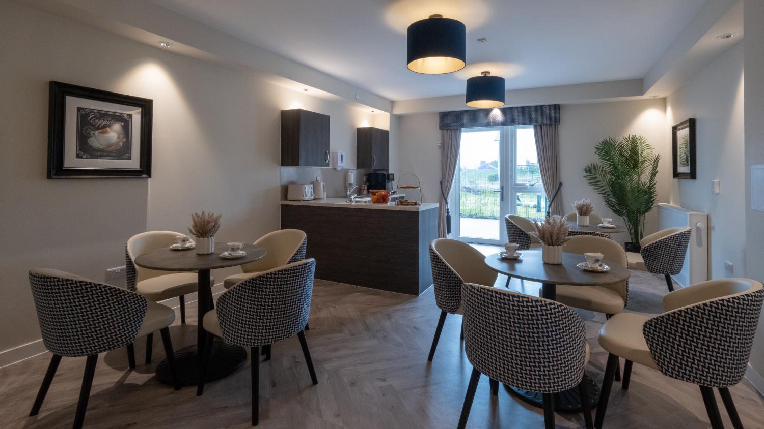 cafe in a care home with a bar and armchairs