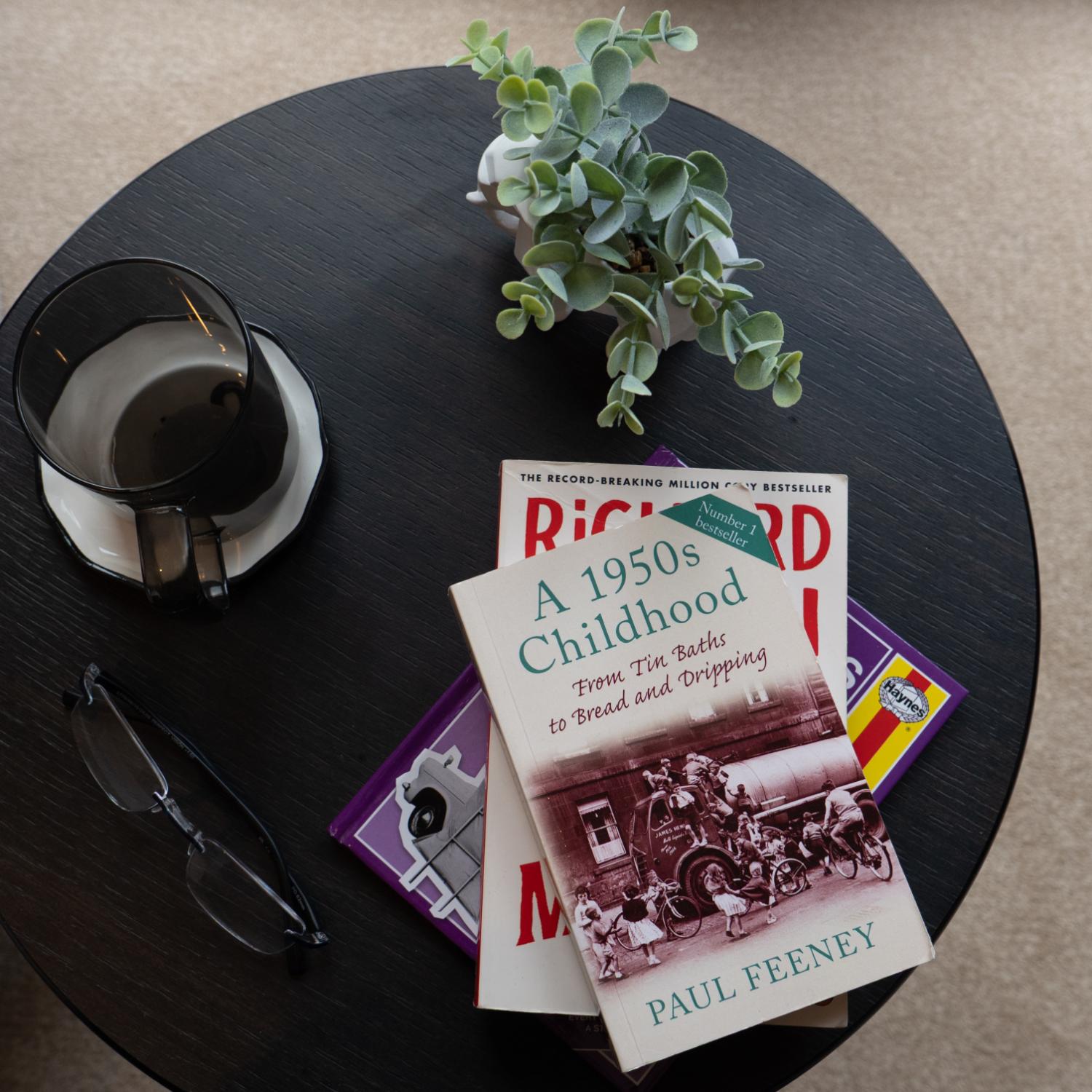 magazines and plants on a round side table