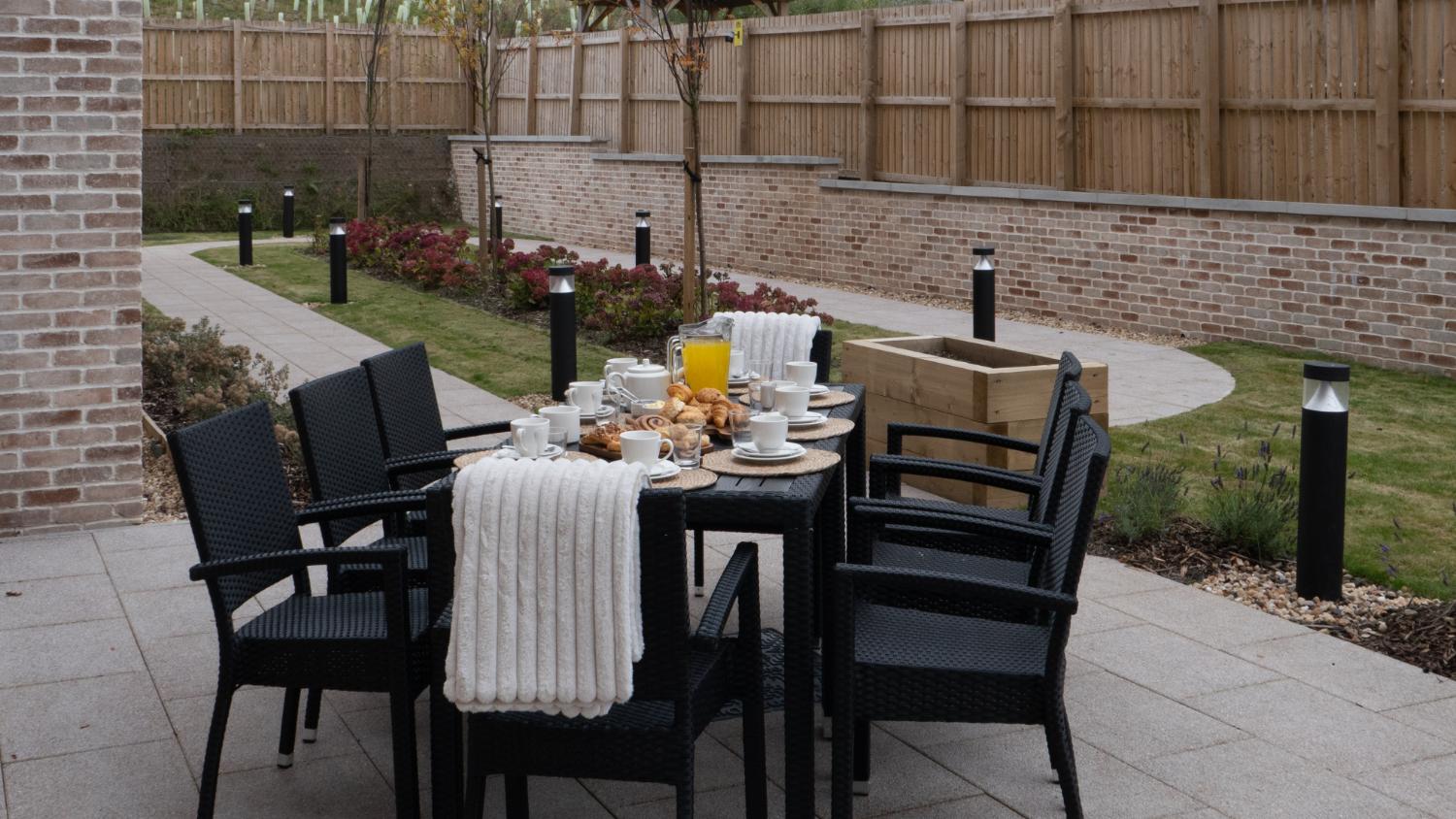 dining table set up on patio for an outdoor breakfast