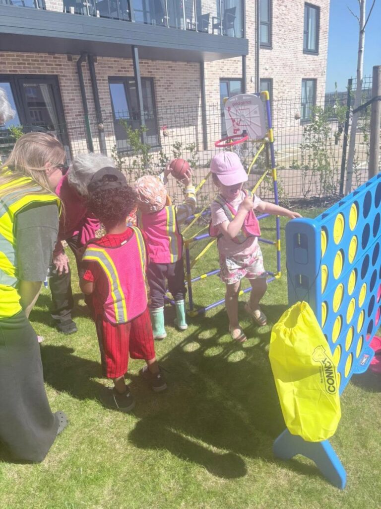 young children visiting a care home outdoors