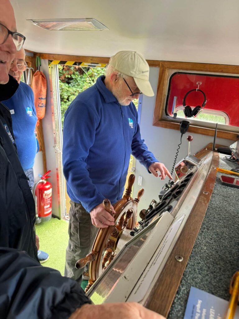 care home resident steering a barge